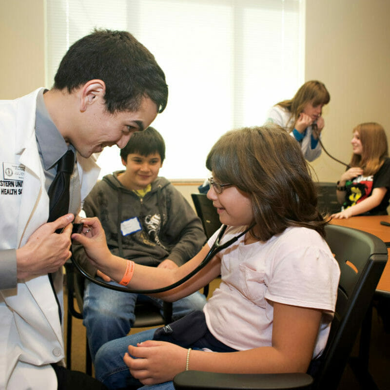 student is teaching kid